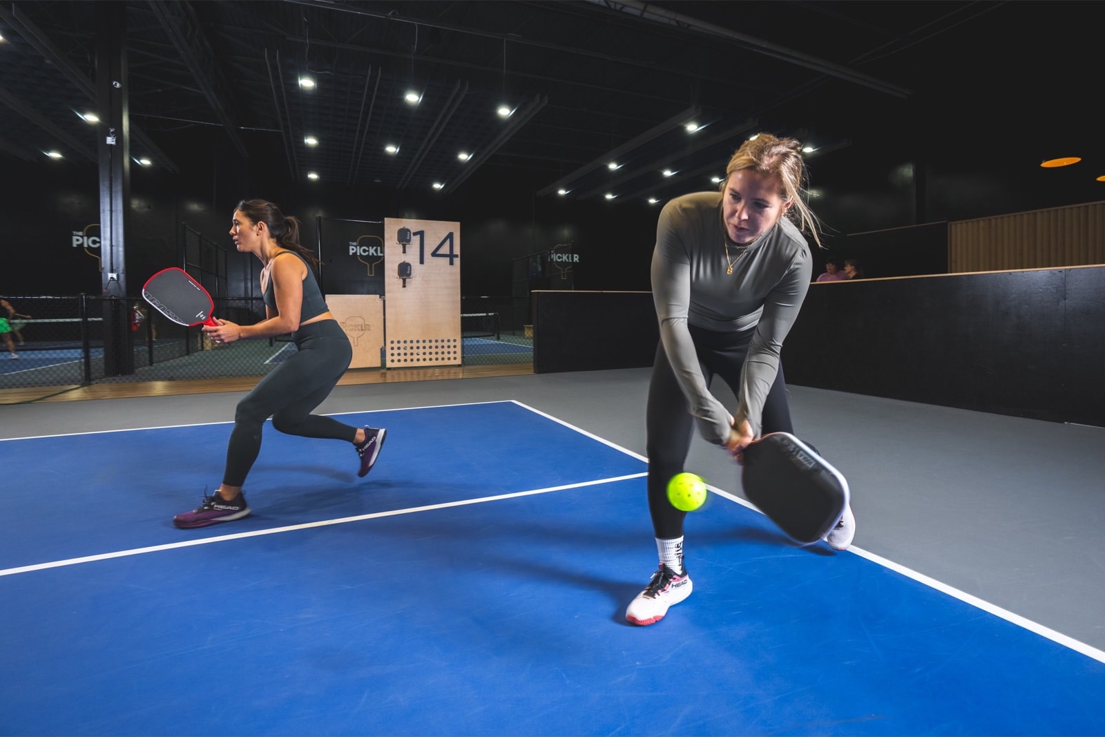 PICKLR player on an indoor court